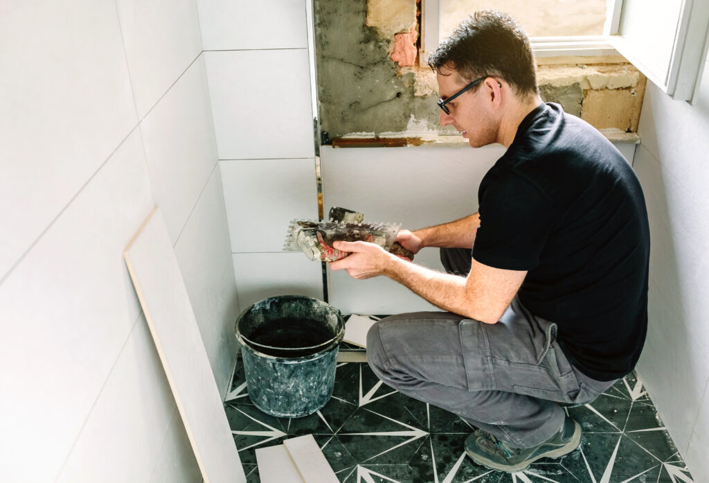 Male mason working on a bathroom renovation